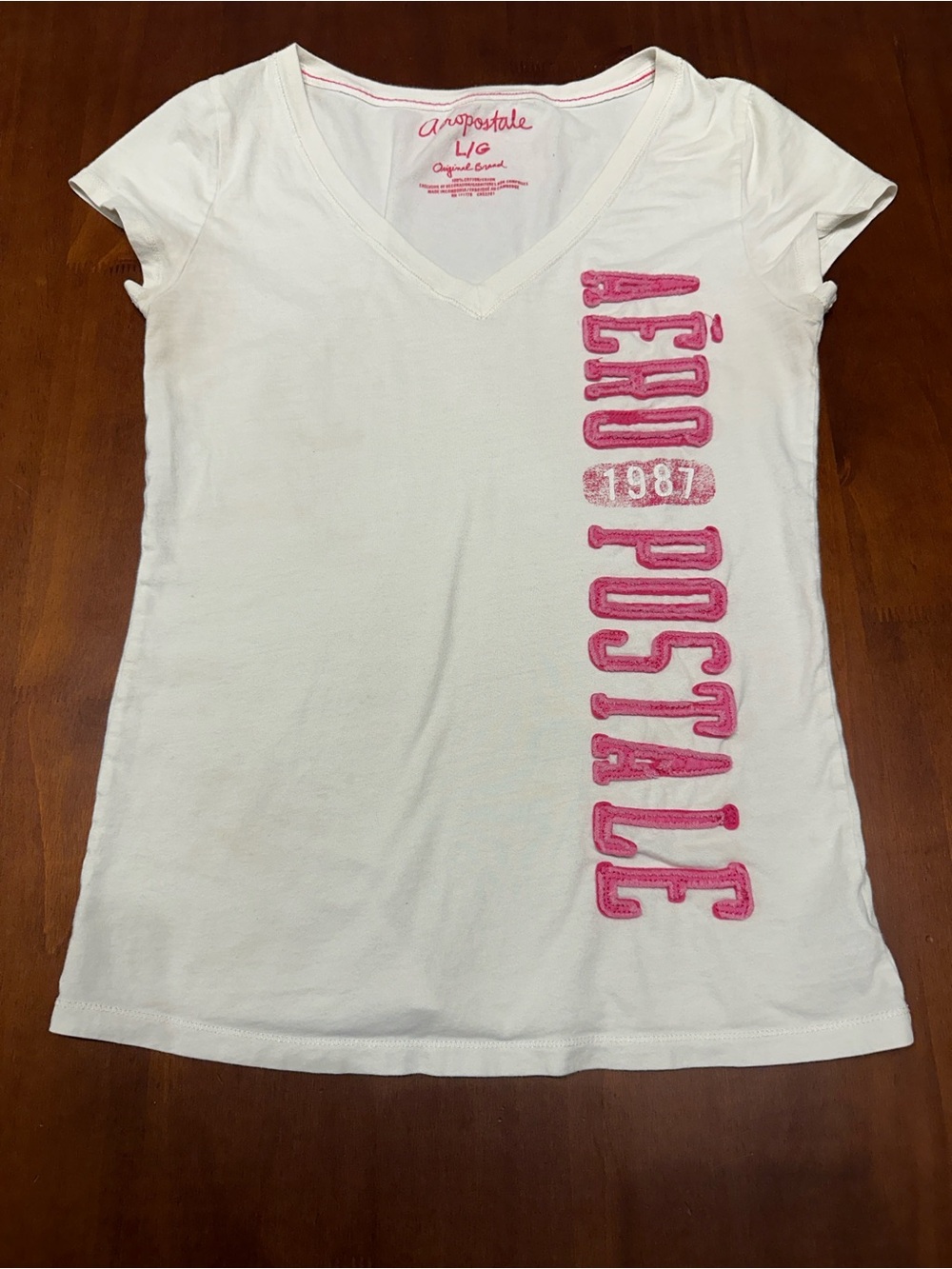 Aeropostale White V‑Neck Tee with Pink Vertical Logo